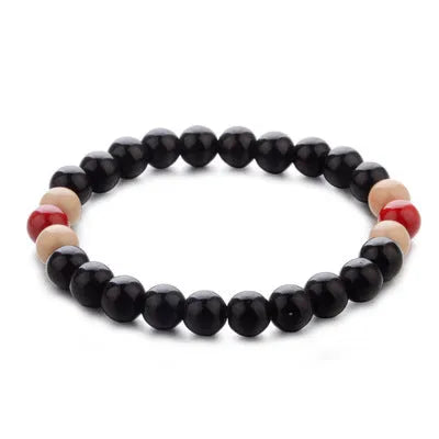 Unisex ethnic-style beaded bracelet with lava stone on a wrist, showing essential oil application.