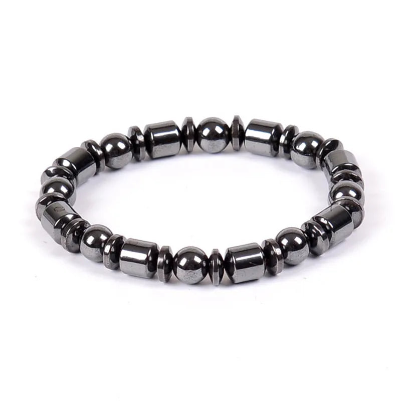 Black pentagram magnetic bracelet with magnetite and hematite stones on a wrist.