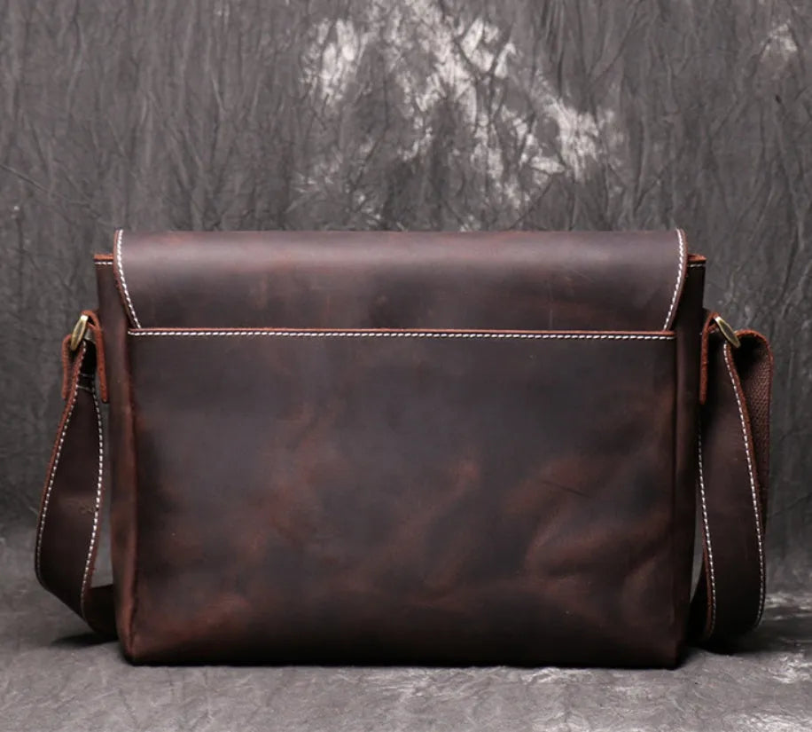 Brown vintage leather men's messenger bag with a flap opening and an adjustable shoulder strap.