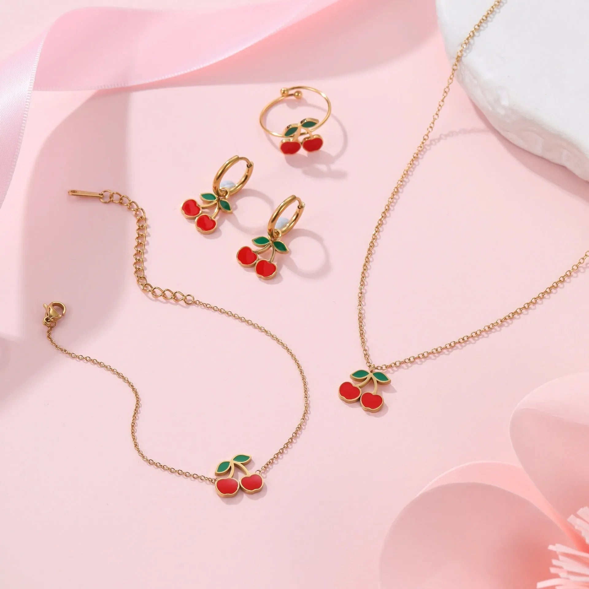 Complete cherry jewellery set showing stainless steel necklace, bracelet, earrings and ring with 18K electroplated finish