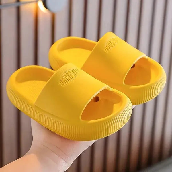 Children's non-slip EVA slippers in bright colours, showing the 1.5cm thick sole.