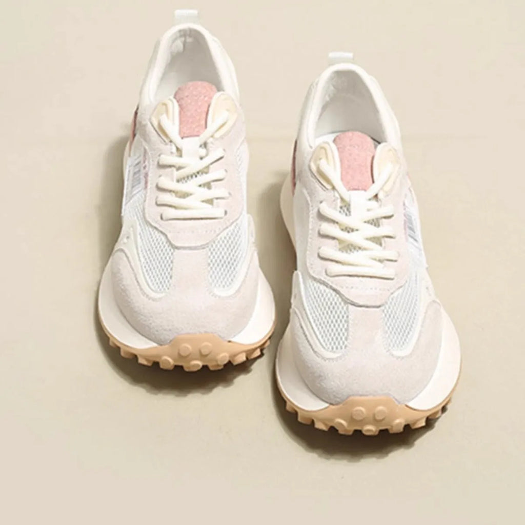 Women's grey retro sneaker with round toe and rubber sole showing mesh lining interior
