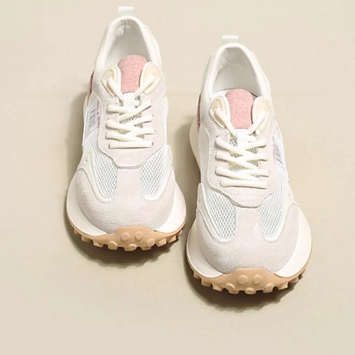 Women's grey retro sneaker with round toe and rubber sole showing mesh lining interior