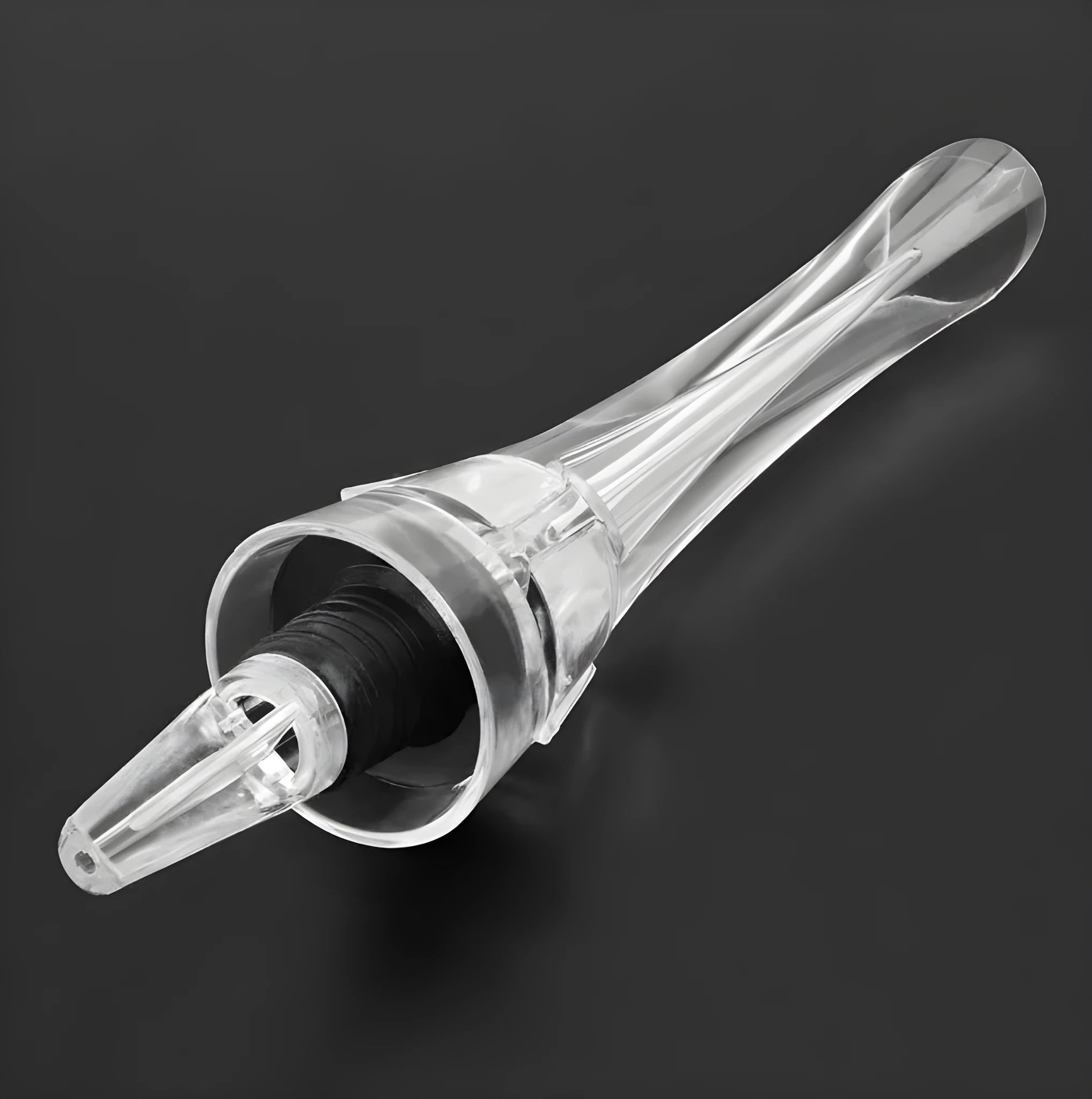 Compact clear acrylic wine aerator with a stainless steel filter insert on a wooden table.