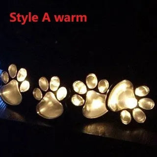Black solar powered bear paw print garden lights set with four lights and solar panel