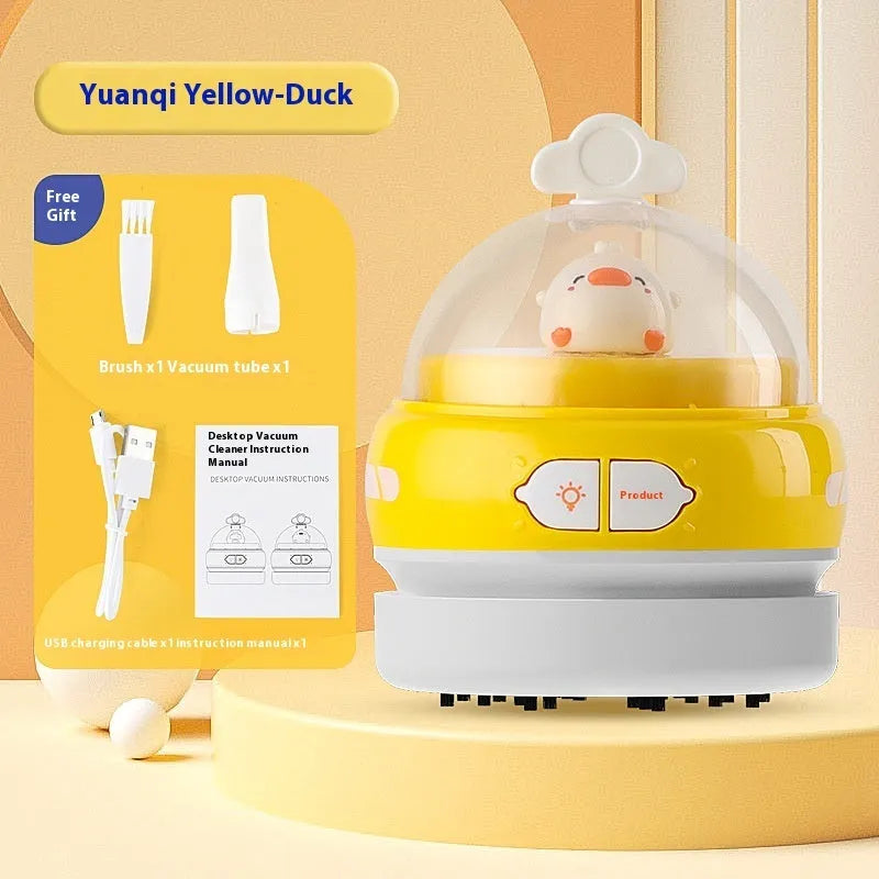 USB charging handheld desktop vacuum cleaner in blue rocket design on computer keyboard