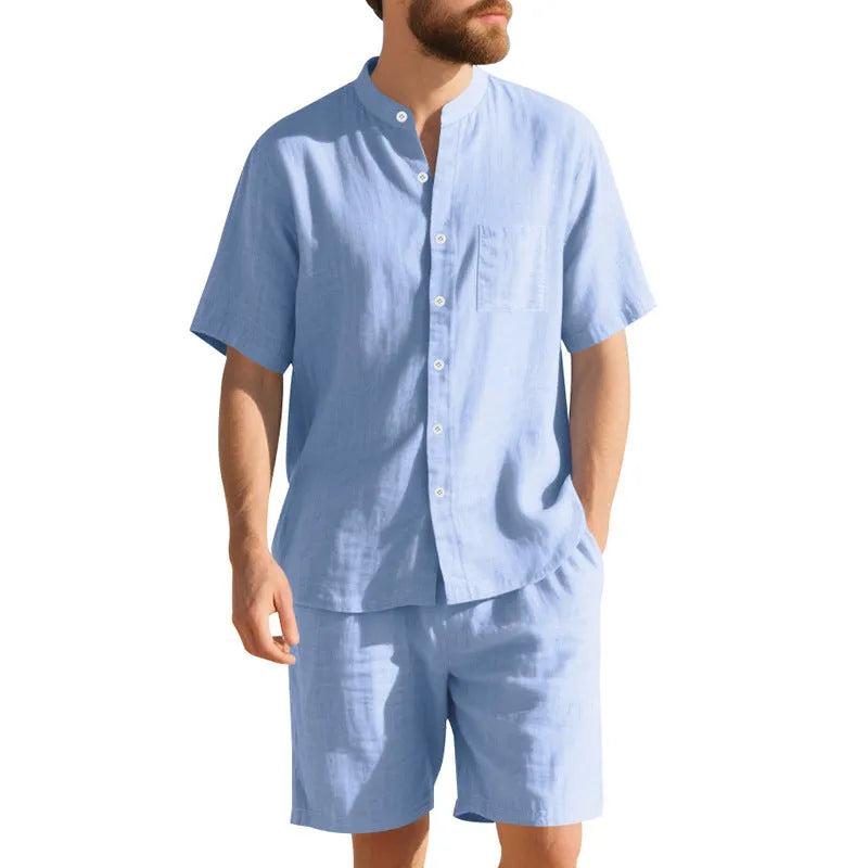 Man wearing a light blue linen blend short sleeve shirt and matching shorts, a casual summer two-piece suit.