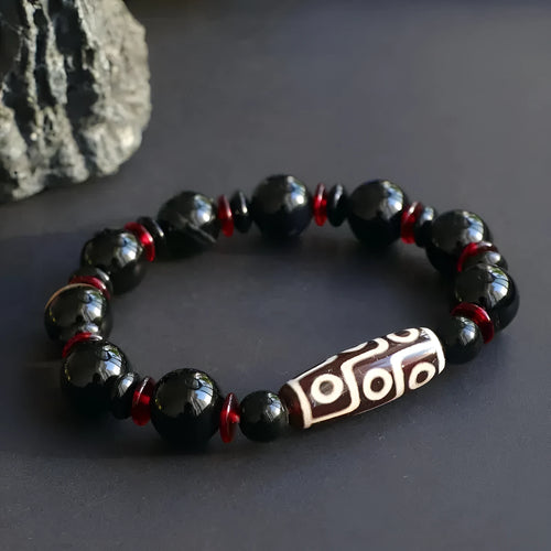 Hand-woven black agate dzi bead bracelet with geometry pattern on wrist