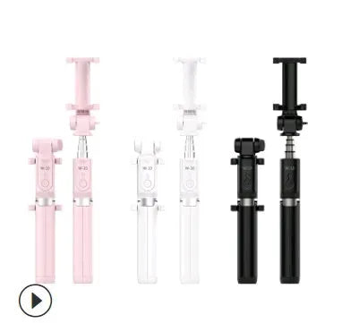 Black Bluetooth selfie stick tripod with remote control extended next to mobile phone