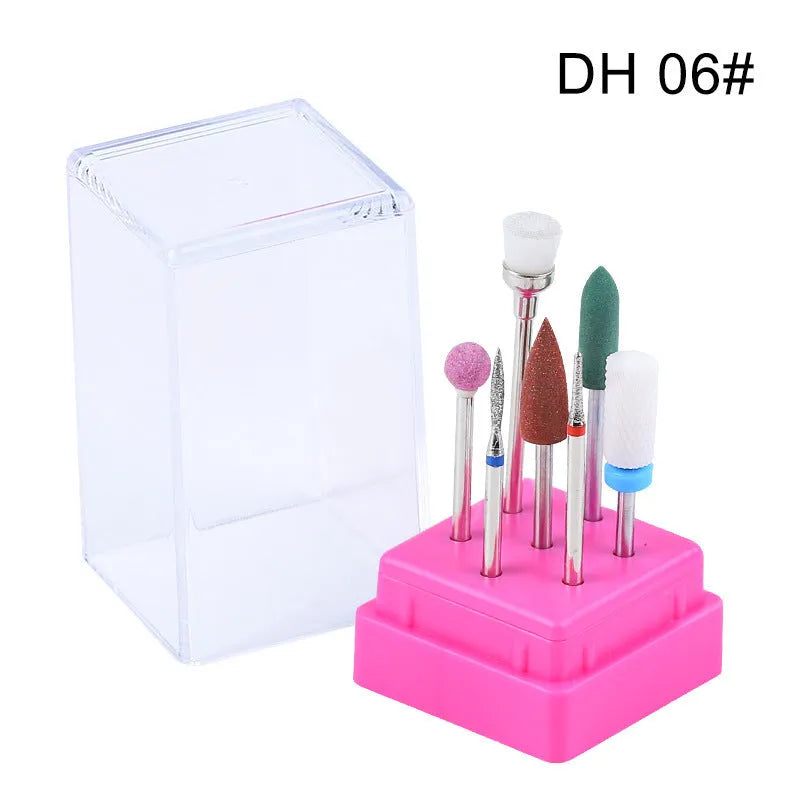 Set of seven tungsten steel nail drill bits and a brush in a transparent storage case.