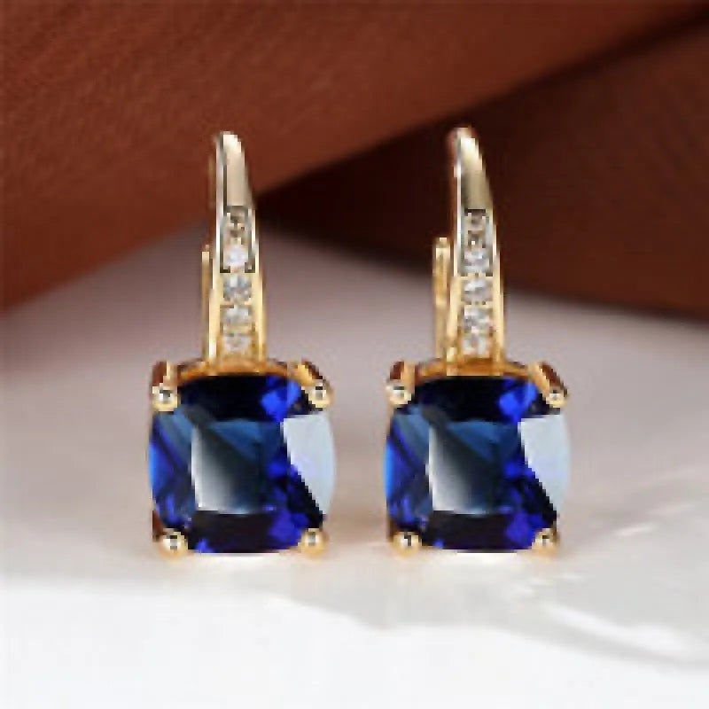 Square geometric ear clips with colourful moissanite stones in gold and silver electroplated finishes.