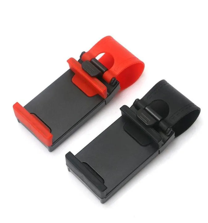 Black steering wheel phone holder clip mounted on car steering wheel holding a smartphone