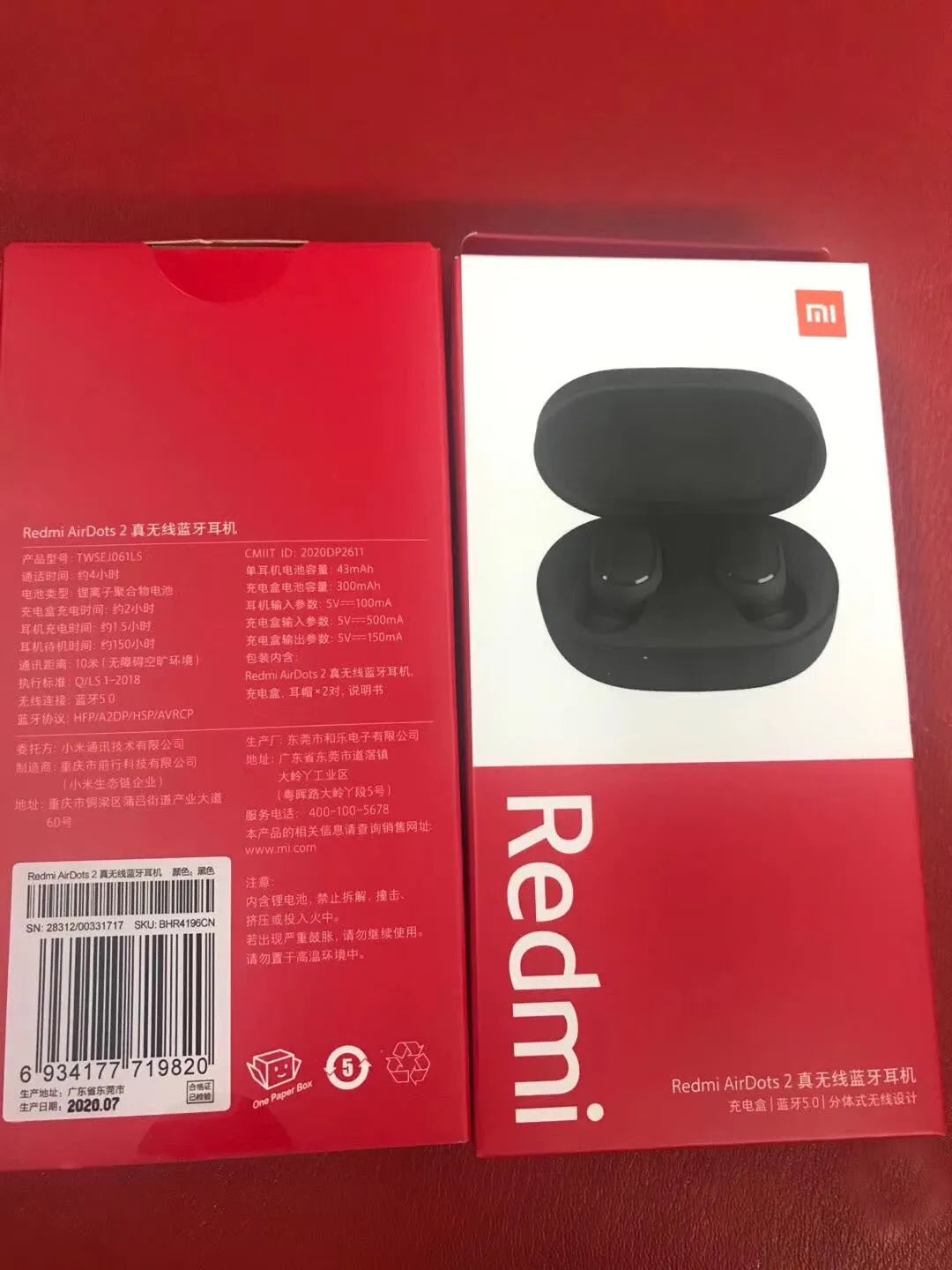 Redmi AirDots Black true wireless earbuds and their white charging case on a table