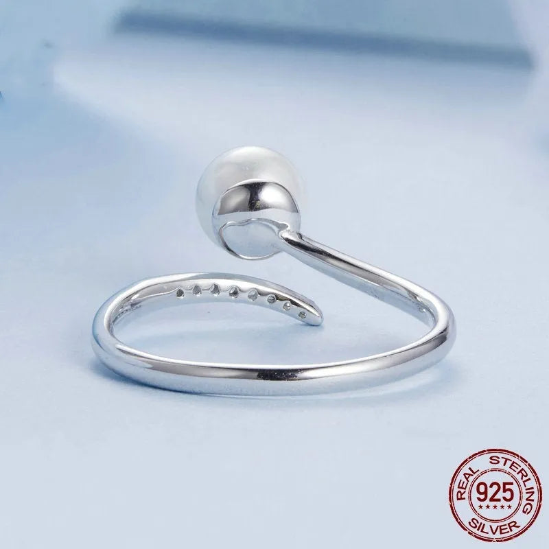 Women's adjustable sterling silver ring with natural pearl on open loop design