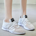 Low-top casual sneaker with a white mesh upper featuring a hollow breathable design and a flat EVA sole.