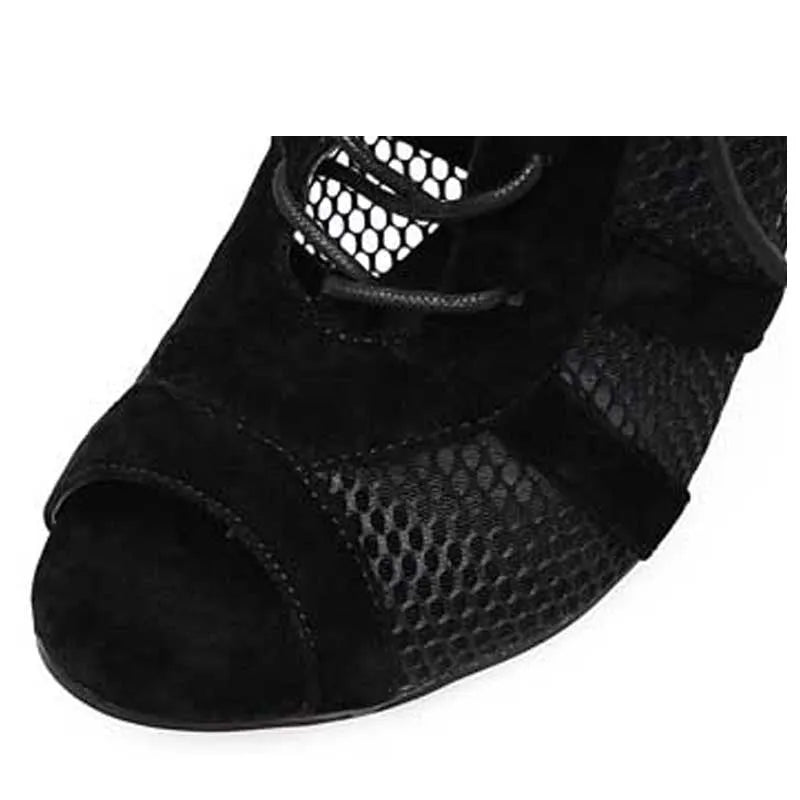 Black suede women's lace-up high heel shoes with 11.5cm heel on wooden floor
