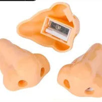 Flesh coloured plastic pencil sharpener with big nostril hole showing compact geometry shape