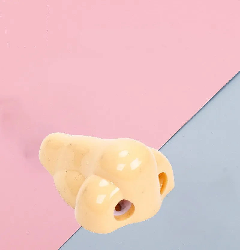 Flesh coloured plastic pencil sharpener with big nostril hole showing compact geometry shape