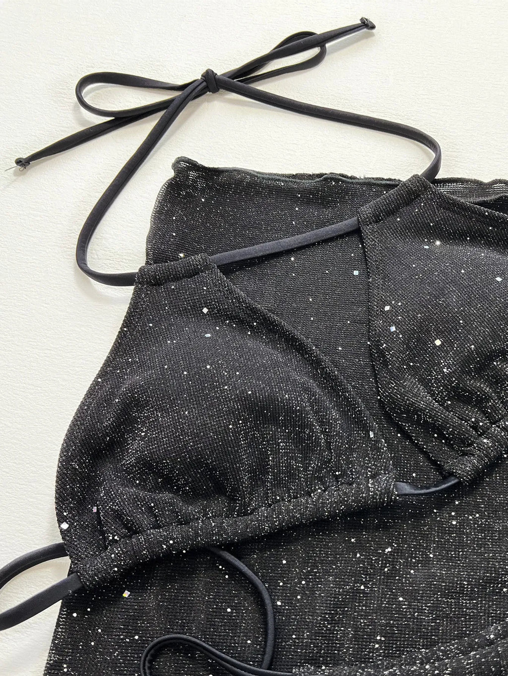 Black three-piece swimsuit bikini set with separate top and shorts