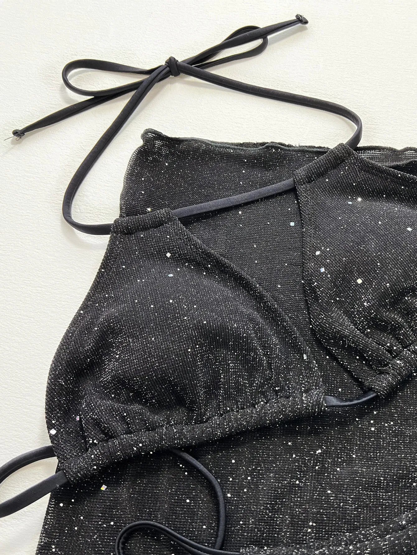 Black three-piece swimsuit bikini set with separate top and shorts
