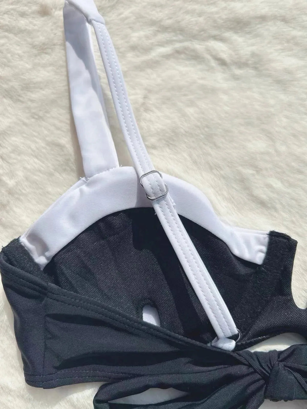 Women's black low waist bikini swimsuit with stitching detail and split brief design