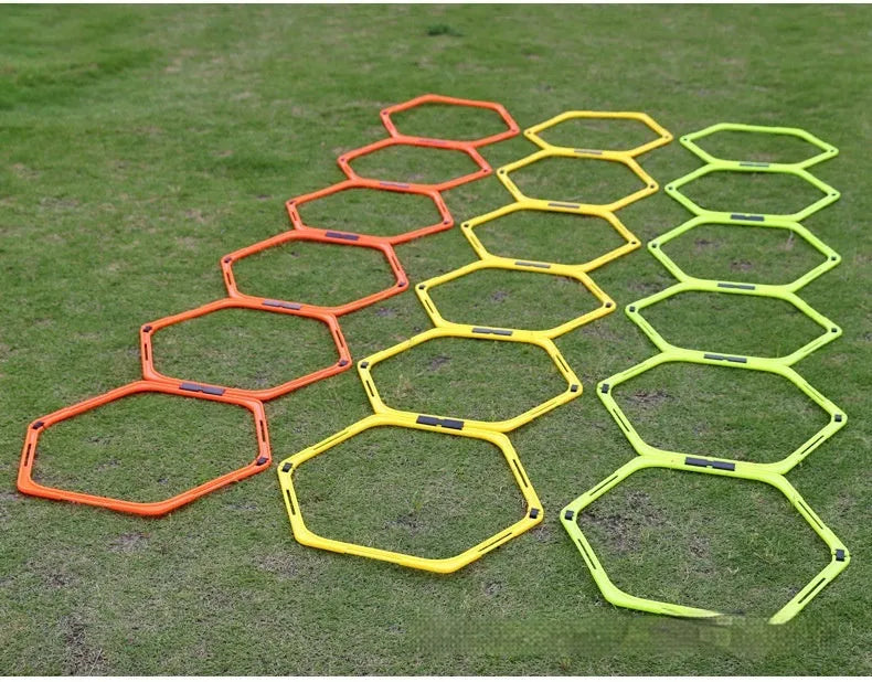 Set of six foldable yellow, green, and orange hexagon plastic agility rings for football training.