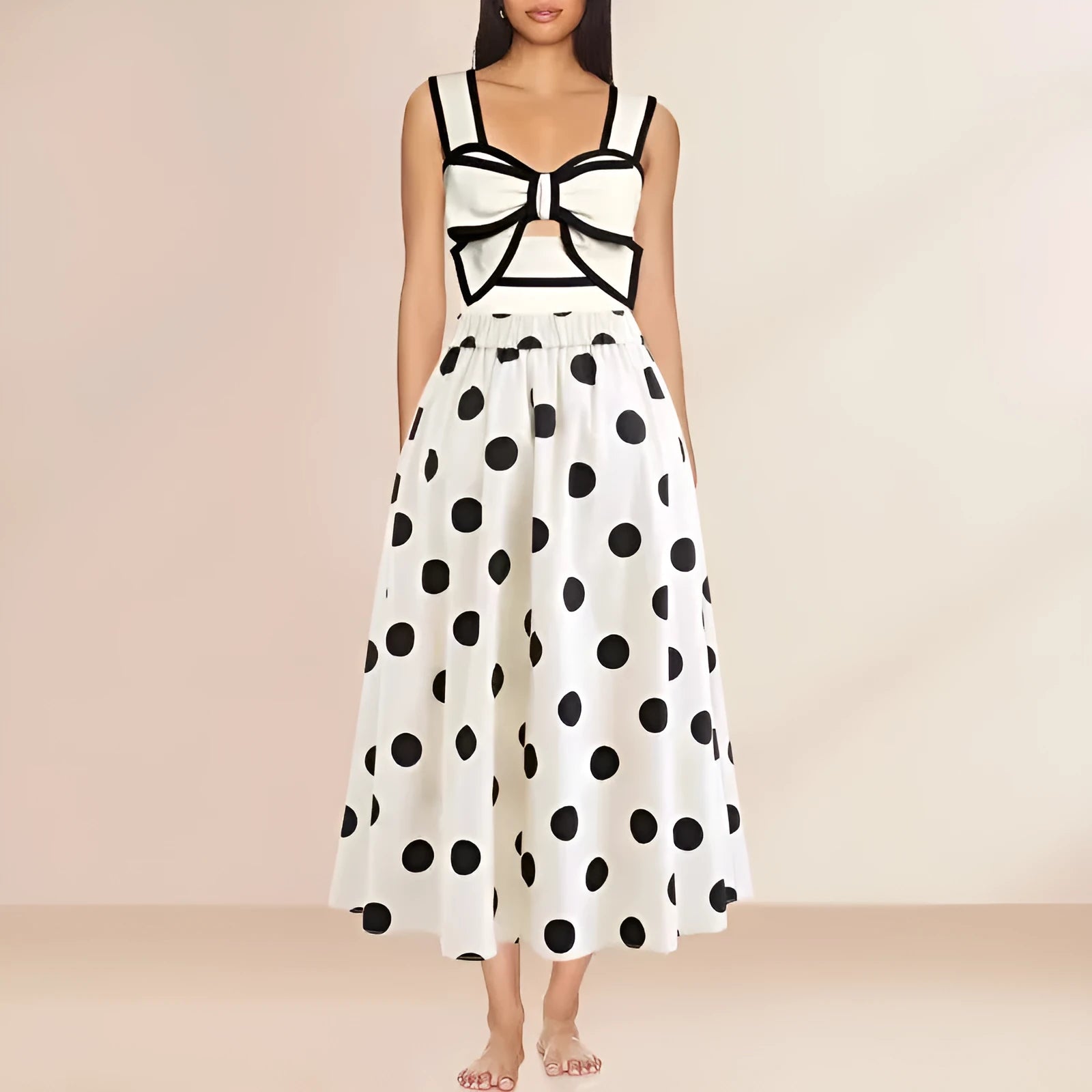 Black one-piece women's swimsuit with a flared round skirt and a decorative bow on the front.