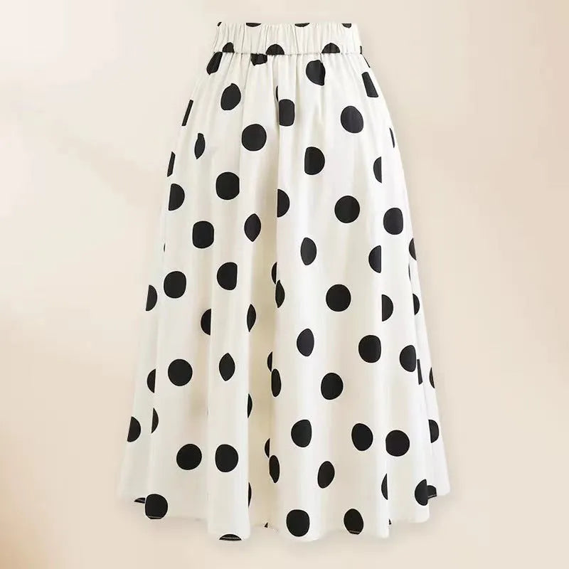 Black one-piece women's swimsuit with a flared round skirt and a decorative bow on the front.