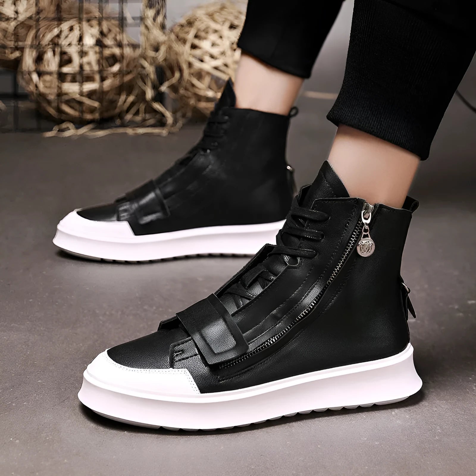 Man wearing black PU leather high-top sneaker style winter ankle boots.