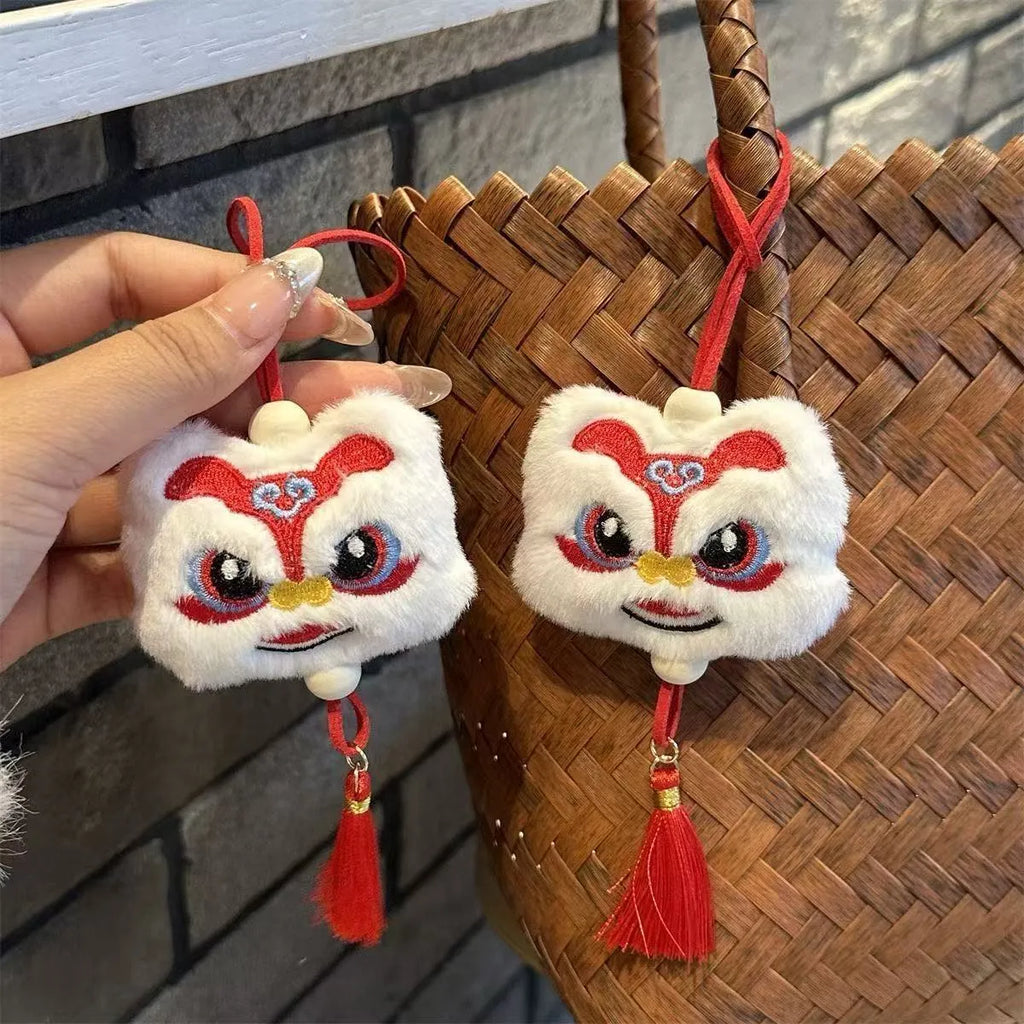 Blue and yellow cartoon plush lion keychain ornament with tassel and star stone.