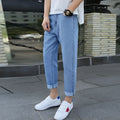 Men's black loose straight-leg jeans with small harem opening on hanger