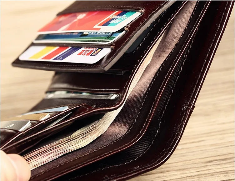 Men's leather wallet showing internal card slots, coin compartment, and document section