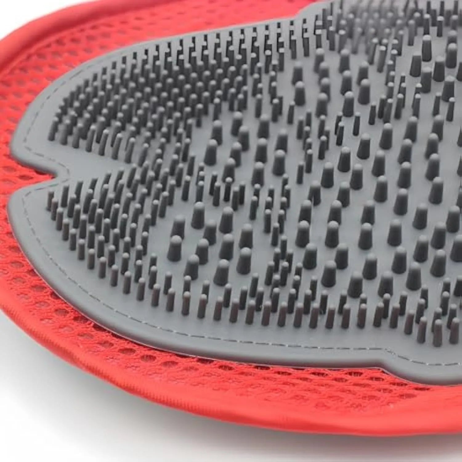 Red pet bathing and grooming glove combining a brush and mitt, shown on a hand.