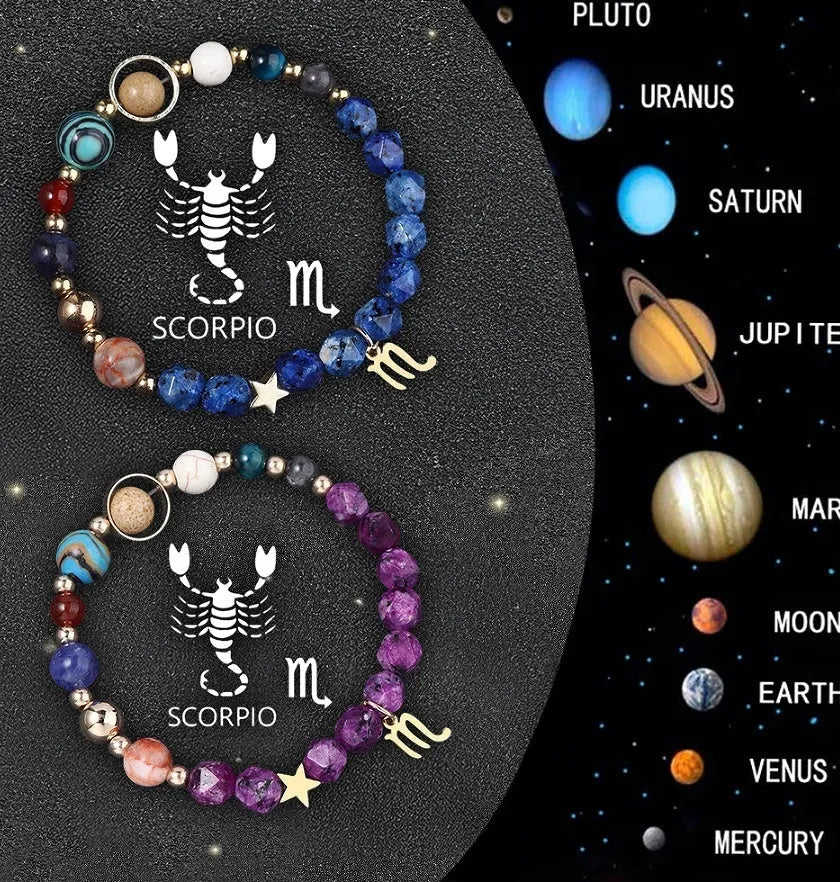 Set of two natural stone beaded bracelets with metal zodiac charms on a dark background.
