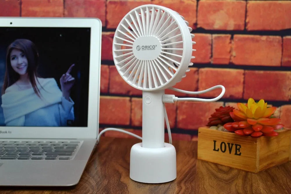 White ORICO FH1 portable USB desk fan with rechargeable battery on a desk