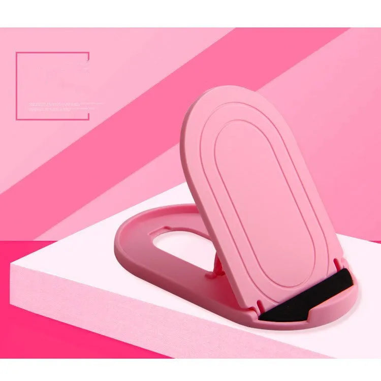 A lazy bracket style mobile phone stand made of plastic, shown in multiple colour options on a wooden desk.