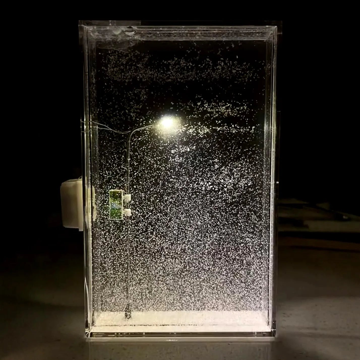 DIY material kit for assembling a snowy landscape night light with small street lamp and LED lights.