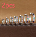 Gold, rose gold, and silver coloured circle-shaped zircon stud earrings on a white background.