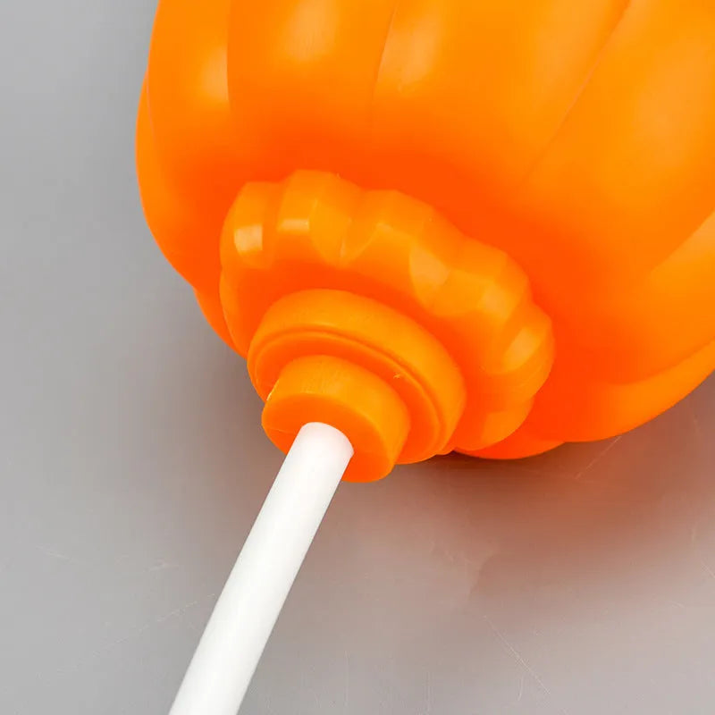 Plastic pumpkin-shaped USB lamp emitting purple or yellow light, 8.3cm wide.