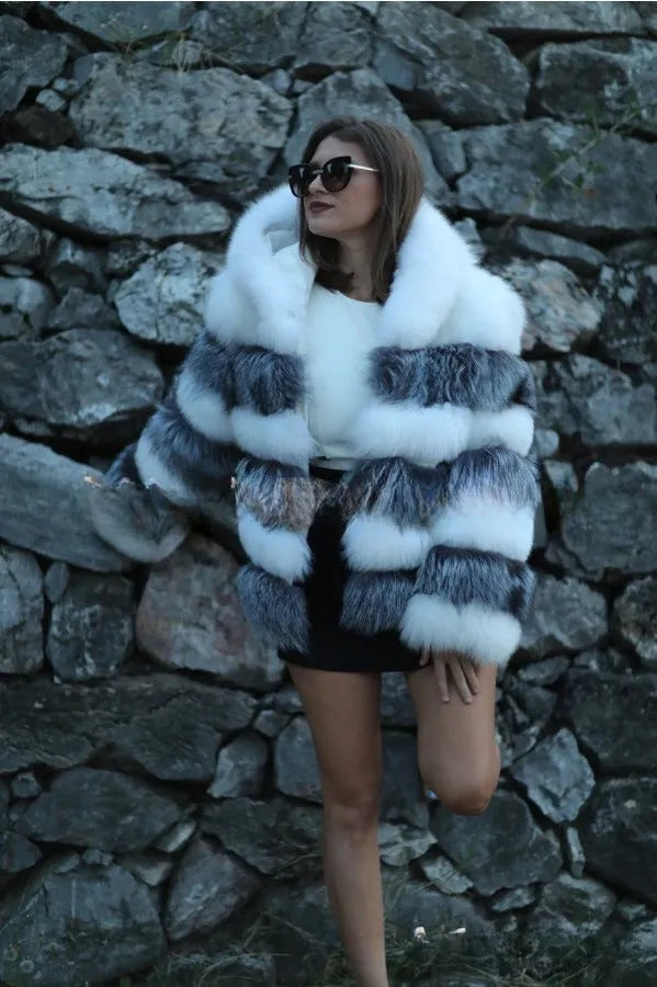 A woman's loose-fitting artificial fur hooded coat in street fashion style.