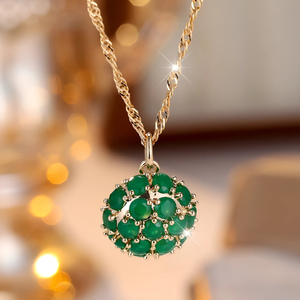 Women's champagne gold necklace with round emerald pendant and diamond accents on copper chain