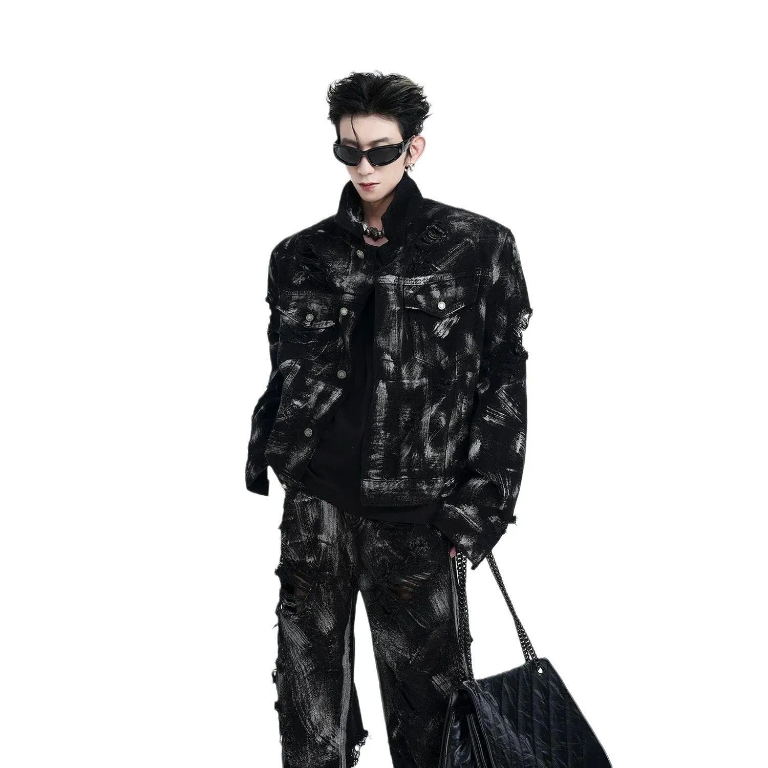 Men's black denim jeans with a heavyweight washed and graffiti-style distressed finish on the legs.