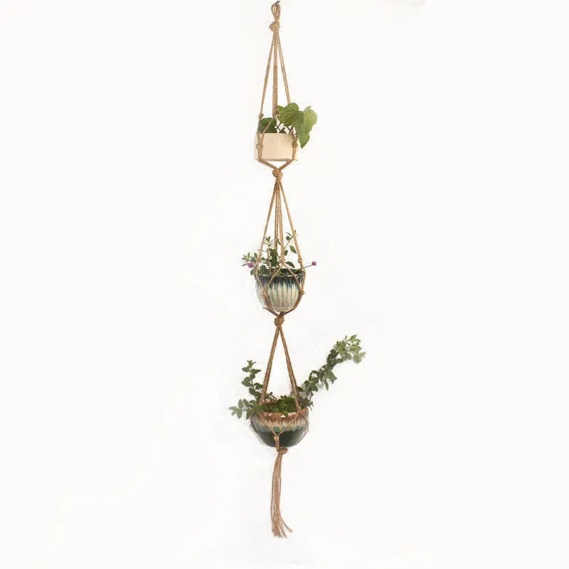 Woven cotton rope plant holder in a desktop style with greenery inside.