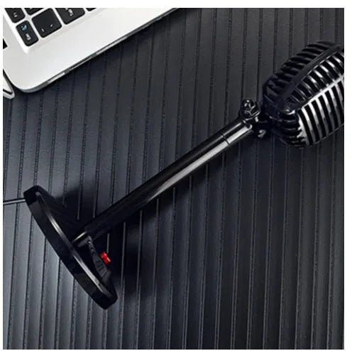 Black USB desktop microphone on a weighted stand with a pop filter and long cable.