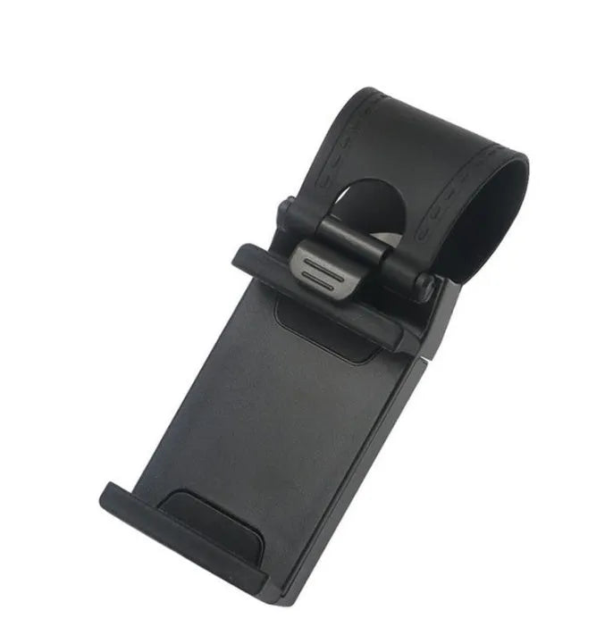 Black steering wheel phone holder clip mounted on car steering wheel holding a smartphone