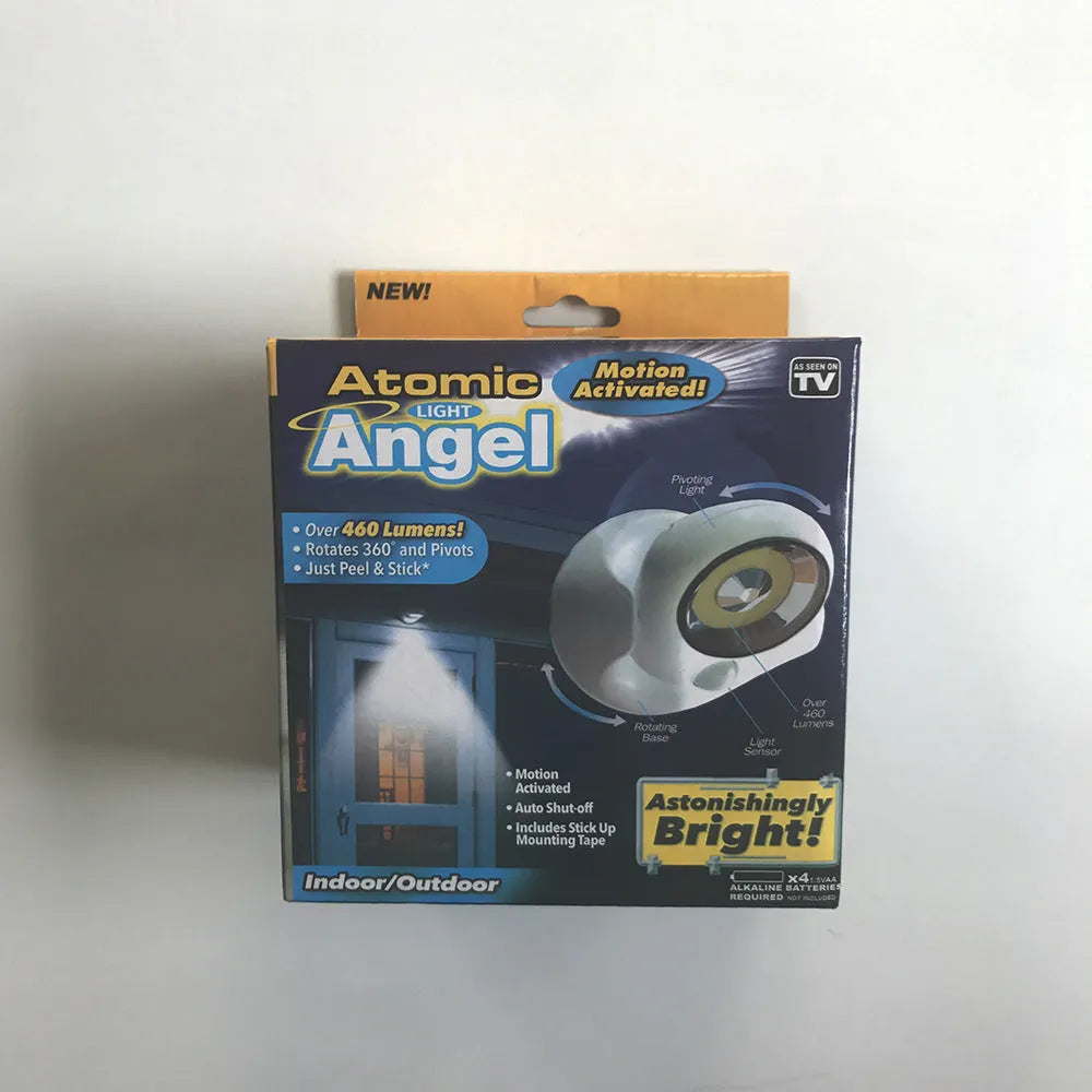 White Atomic Angel induction-activated LED night light on a surface.