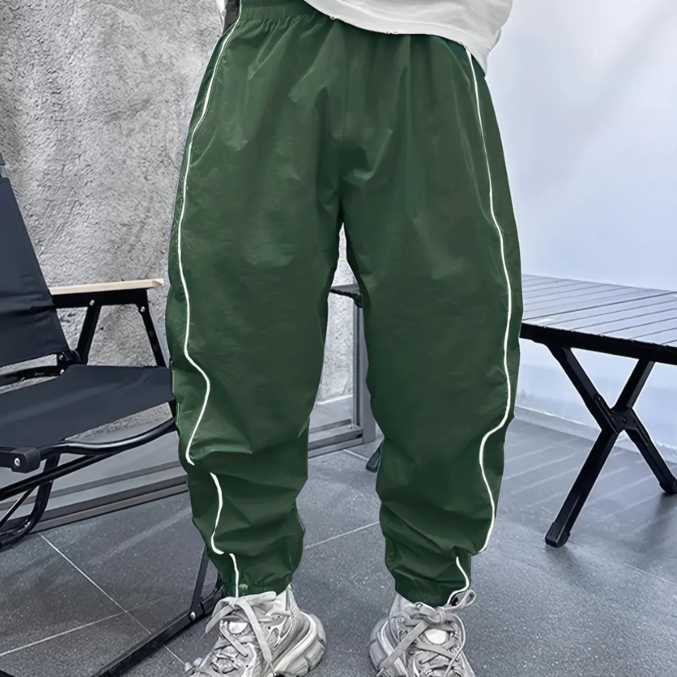 Man wearing blue bamboo fibre casual trousers with a cropped leg and loose fit.