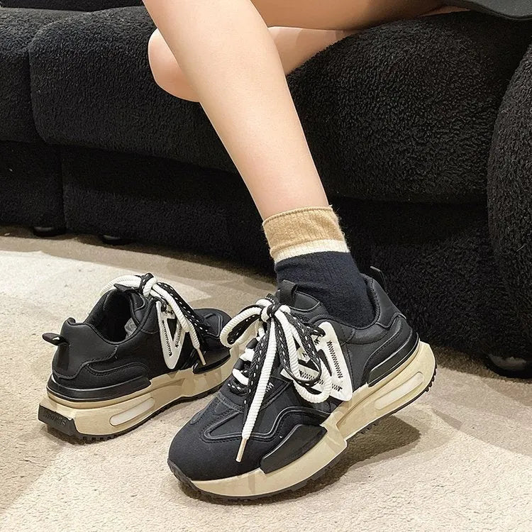 Women's black retro platform sports shoes with round toe and lace-up design on a white background.