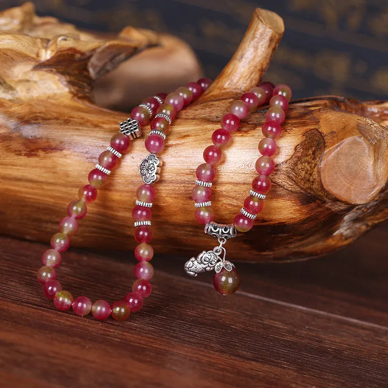 Handmade bracelet with a watermelon crystal elephant bead on a Chinese knot cord.