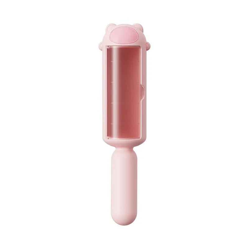 Blue reusable pet hair remover roller with self-cleaning base on a fabric sofa.